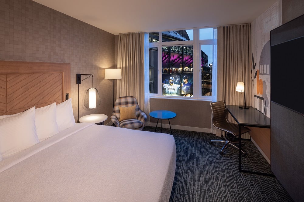 hotel room with king bed and window overlooking stadium