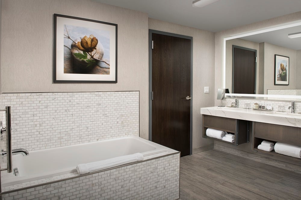 huge hotel bathroom with large soaking tub and double sinks