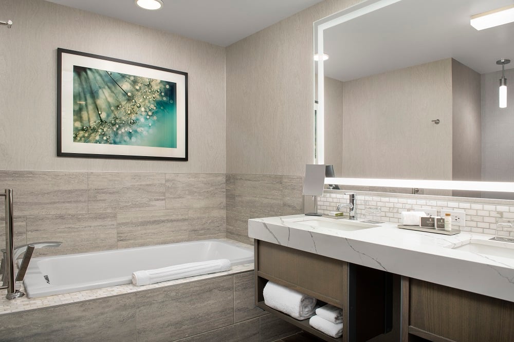 hotel bathroom with marble counter tops and large soaking bath