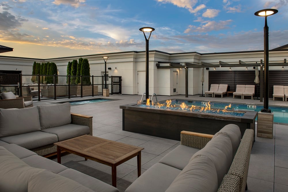outdoor seating next to pool and spa at dusk