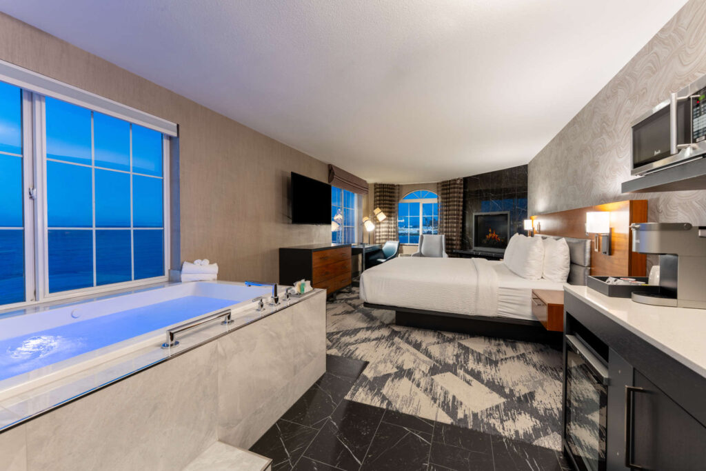 Modern hotel room at Silver Cloud Mukilteo with jacuzzi and ocean view.
