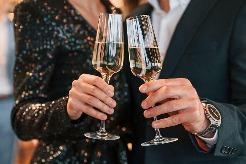 Couple holding champagne glasses.